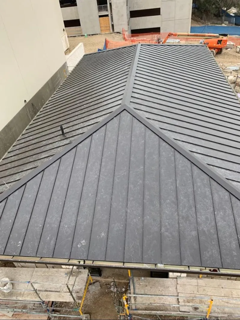 Commercial metal roof construction with crane equipment in Stevenson Ranch