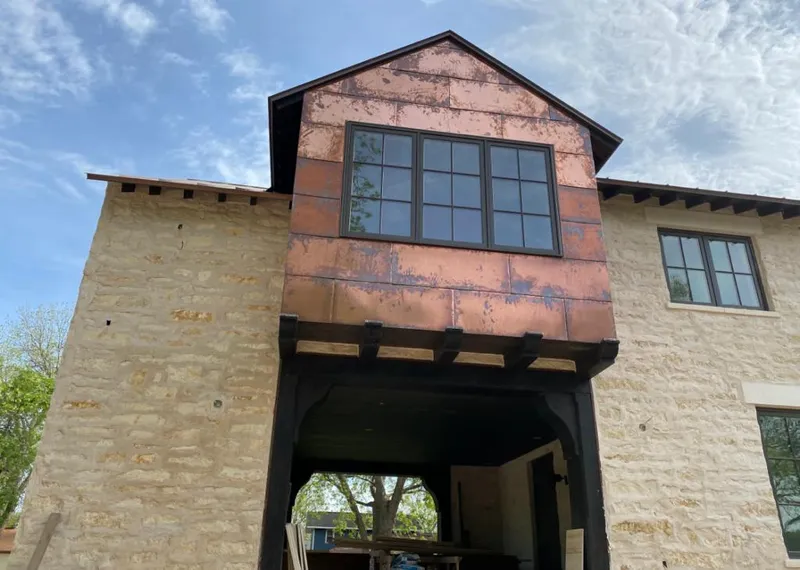 Copper metal panel facade on a stone building for Skylight Installation in Stevenson Ranch